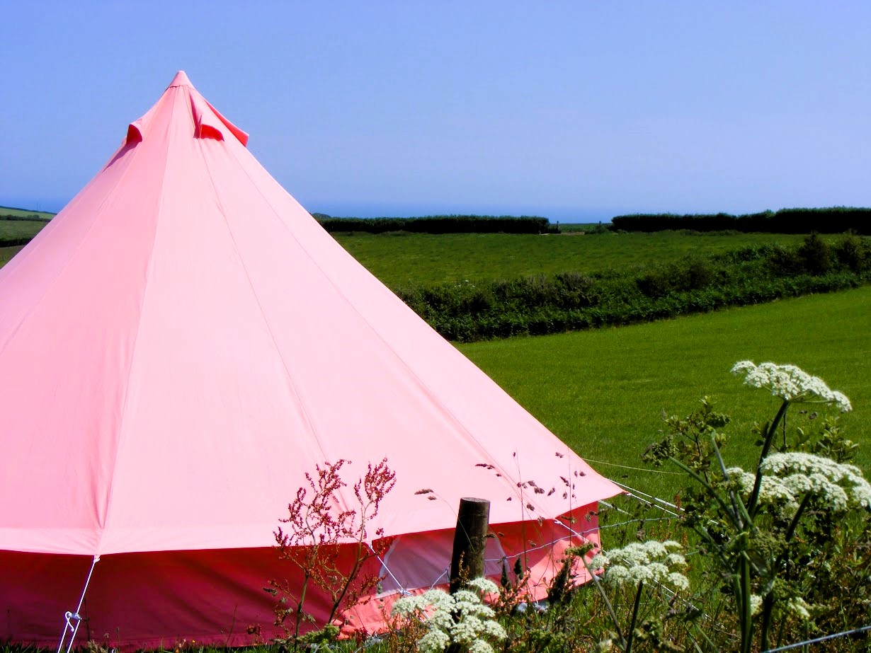 Pink bell tent at Sea View Camping in South Devon. We welcome tents, caravans and camper vans at our small independent farm Devon campsite